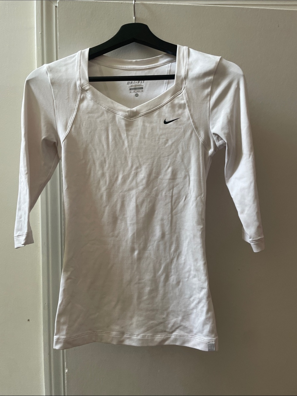 Nike White Long Sleeve V-Neck Athletic Top with Black Swoosh